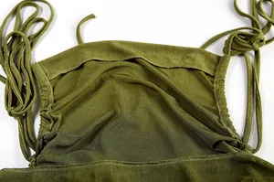 Detailed macro view of an olive green halterneck dress showing tie-up straps and fabric
