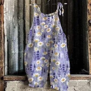 Close-up detail of vintage floral print jumpsuit with daisy patterns hanging on rustic wall