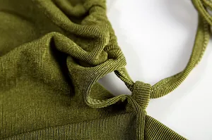 Close-up of olive green ribbed fabric and drawstring detail on halter dress
