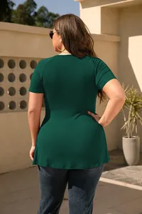 Back view of a plus-size dark green short-sleeved t-shirt in a sunny outdoor setting