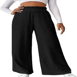Close-up detail of women's black ribbed knit wide-leg pants showing texture and loose fit