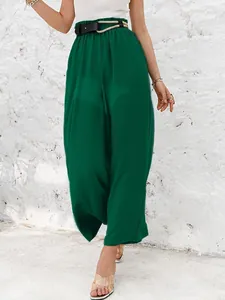 Close-up of green high-waisted wide-leg trousers featuring a rustic braided rope belt accessory