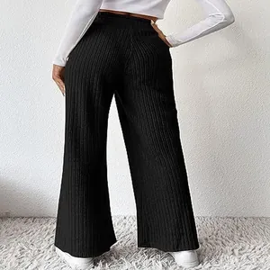 Back view showing the fit and texture of black ribbed knit wide-leg trousers for women