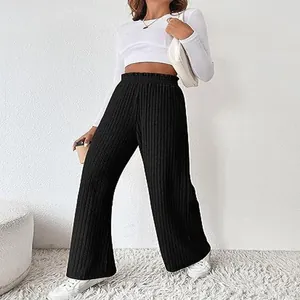 Detail view of black ribbed knit wide-leg pants with elastic high waist.