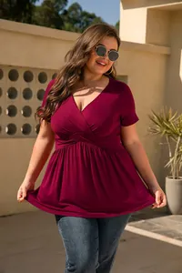 Detailed shot of wine red plus size V-neck peplum top featuring pleated waist design