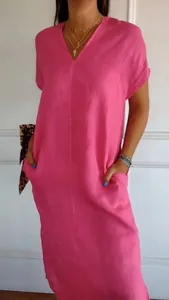 Close-up detail of a pink cotton linen V-neck dress featuring practical side pockets