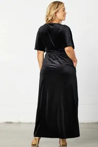 Rear view of an elegant black velvet maxi dress featuring a high waist and short sleeves
