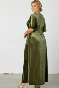 Detailed side view showing the shimmering texture and elegant drape of velvet dress