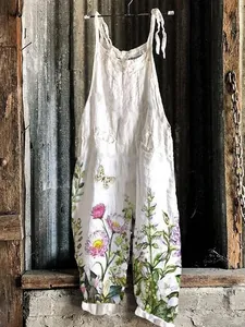 Close-up detail of the sweet floral and butterfly print on vintage white wide-leg jumpsuit