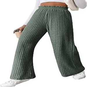 Close-up detail of women's green ribbed knit wide leg trousers styled with sneakers