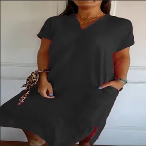 Detail view of black cotton linen V-neck dress with loose fit and side pockets