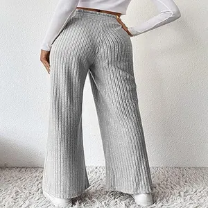 Back view of stylish grey ribbed wide-leg knit trousers for women in minimalist setting