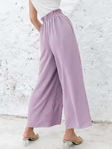 Back view of purple cotton linen high-waisted wide-leg pants with elastic waist