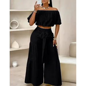 Élégant ensemble deux pièces noir pour femme avec crop top sans épaules et pantalon large