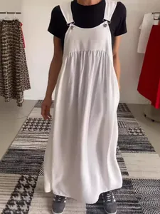 Elegant white cotton linen women's pinafore long dress styled with a black t-shirt