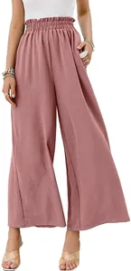 Detailed view of high-waisted wide-leg cotton linen trousers in dusty pink color.