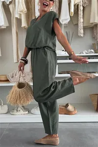 Lifestyle view of women's dark green linen-style casual set in a bright closet decor