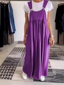 Full body shot of a woman wearing a casual purple cotton linen strap maxi dress for summer