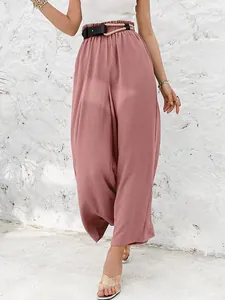 Detail shot of dusty rose high-waist wide-leg pants with elastic paper-bag waist.