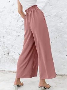 Detailed view of the gathered high-waist design on these dusty rose wide-leg pants