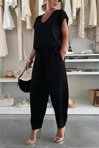 Full view of black linen leisure set in a chic fashion boutique setting