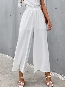 Detailed view of high-waisted white wide-leg trousers in breathable cotton linen fabric