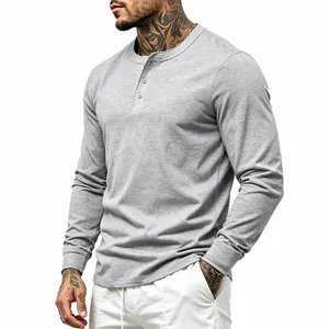 Detail view of a grey men's long-sleeved Henley shirt with button placket and ribbed cuffs