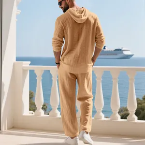 Back view of men's tan linen hoodie and pants two-piece leisure set on a balcony