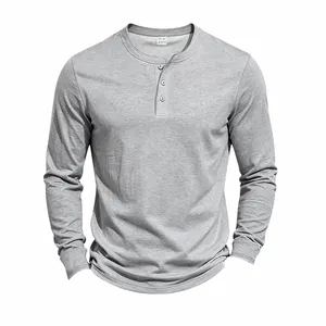 Close-up detail of gray men's knit long-sleeve Henley shirt with button placket