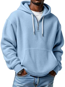 Fashionable men's light blue waffle knit hoodie with quarter-zip and adjustable drawstring