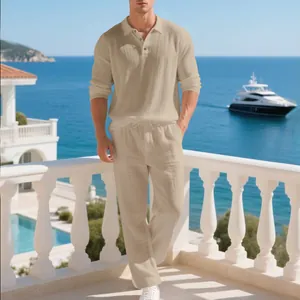 Full body view of men's beige linen polo and trousers set on a sunny seaside balcony