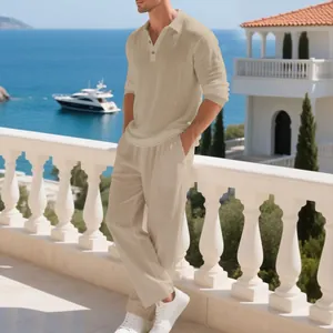 Detail view of men's beige linen polo shirt and pants set on a balcony.