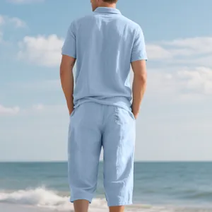 Back view of men's blue linen beach polo shirt and cropped pants set on sunny sea background