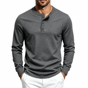 Detailed view of dark gray long sleeve Henley shirt with button placket on men's torso