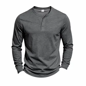 Close-up detail of a grey knitted long-sleeved Henley shirt with button neckline