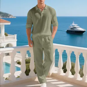 Men's stylish sage green linen polo and pants set on a sunny Mediterranean balcony
