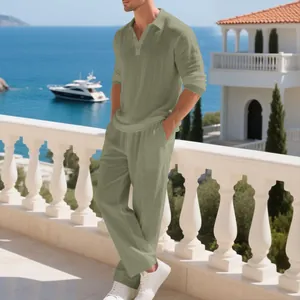 Men's sage green linen polo shirt and pants set shown in a scenic beach resort setting