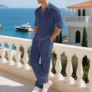 Men's navy linen 2-piece polo set styled on a Mediterranean balcony overlooking the sea