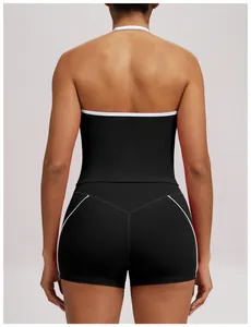 Detailed back view of a black halter yoga top featuring white piping and slim fit