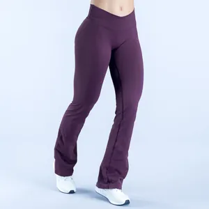 Detailed view of seamless yoga flare leggings with a cross-over high waist in deep purple.