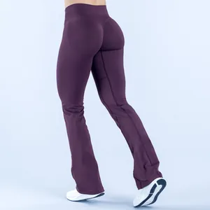 Rear view of dark purple seamless flare yoga pants showing butt-lifting fit and flared hem