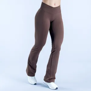 Close-up detail view of seamless brown yoga flare pants featuring a cross waist and lifting fit