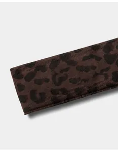 Close-up detail of brown seamless leopard print yoga headband showing soft ribbed texture