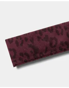 Close-up detail showing the texture of a burgundy leopard print seamless yoga headband