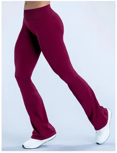 Detailed side view of seamless burgundy flare yoga pants showing micro-flare leg design