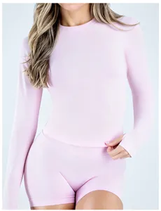 Detail view of pink seamless long sleeve yoga top with thumbholes for fitness.
