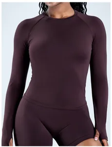 Close-up of a seamless long-sleeve sports top with thumb holes in dark brown.