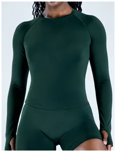 Close-up of dark green seamless long-sleeved athletic top with thumbholes.