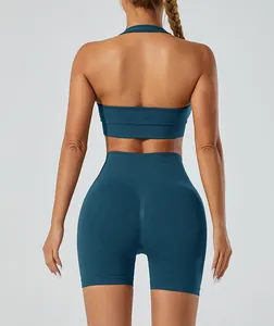 Back view of seamless halter yoga top and high-waist scrunch shorts in deep teal.