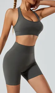 Detail view of dark grey seamless yoga set featuring halter sports bra and high waist shorts.